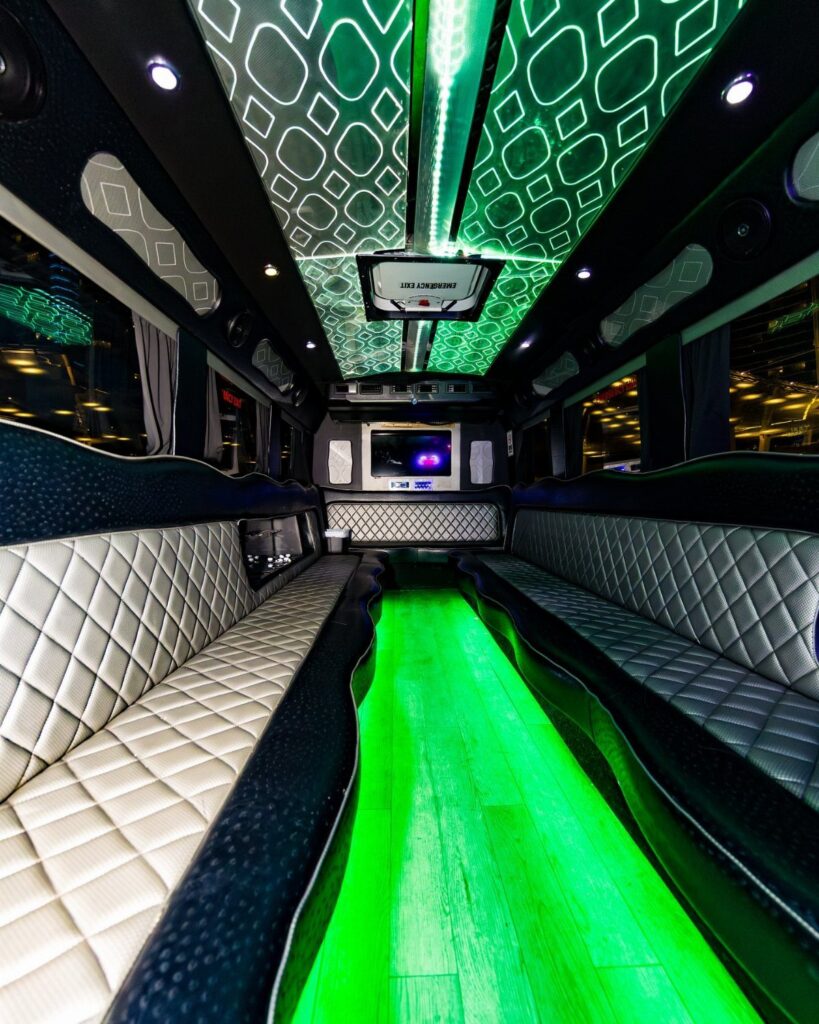 Luxury limousine interior with quilted leather seats and vibrant green neon floor lighting.